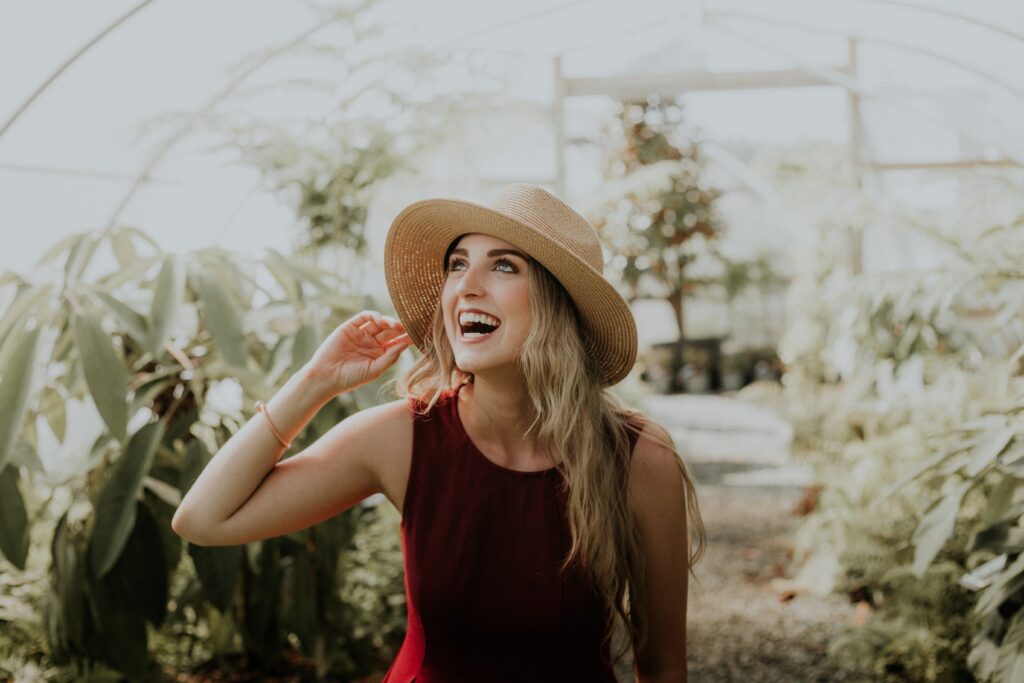 A woman Smiling in a Greenhouse