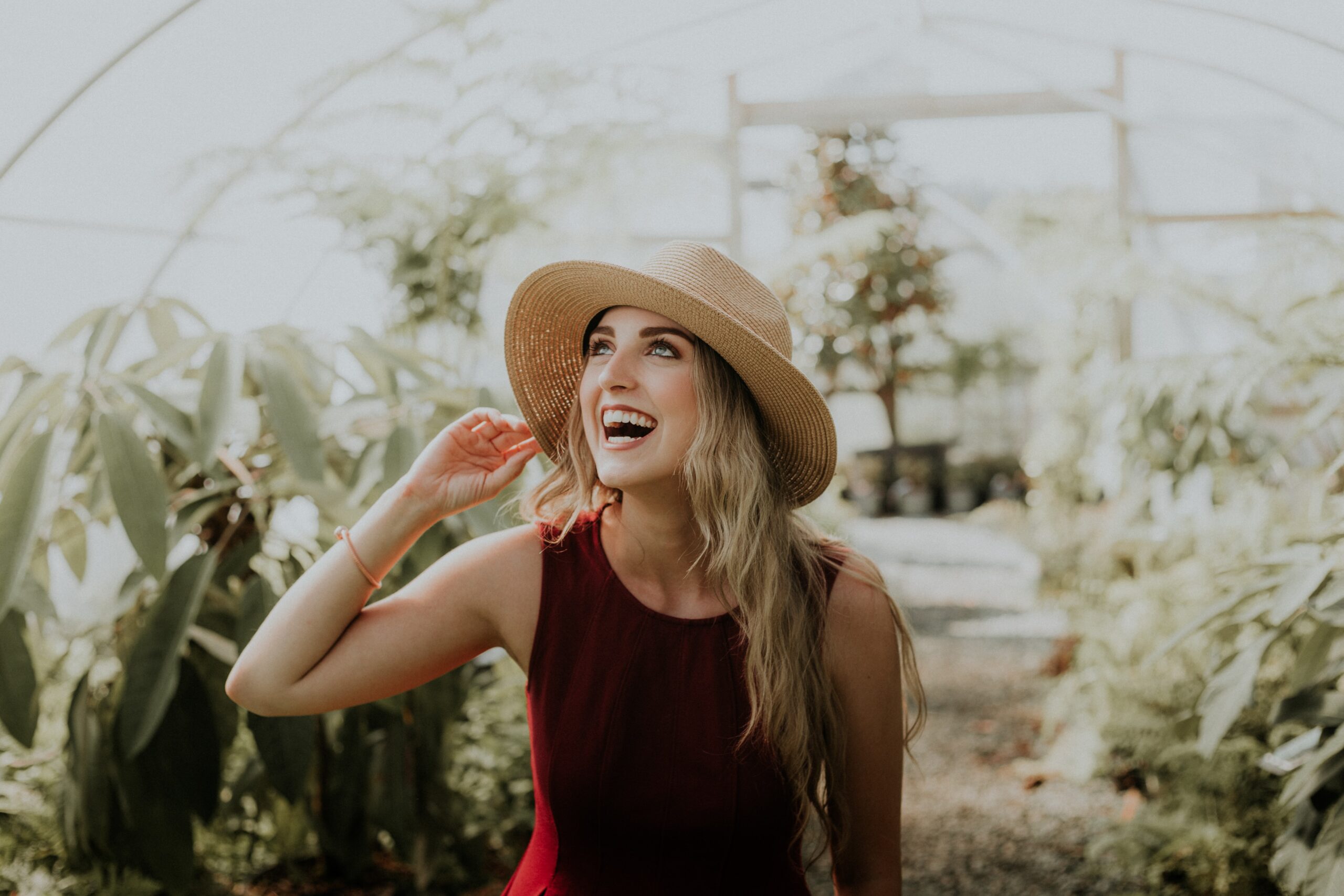 A woman Smiling in a Greenhouse